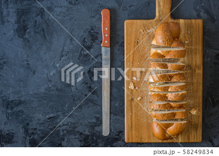 Jewish challah bread, sliced on black background 58249834