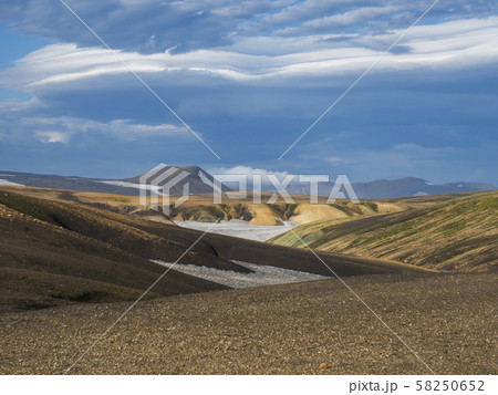 Colorful Rhyolit mountain panorma with snow fiields and multicolored volcanos in Landmannalaugar Colorful Rhyolit mountain panorma with snow fiields and multicolored volcanos in Landmannalaugar 58250652