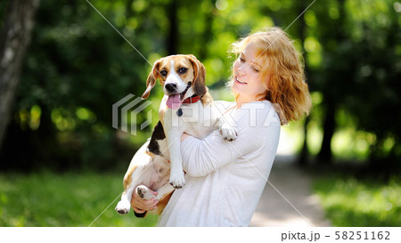 Young beautiful woman with Beagle dog Young beautiful woman with Beagle dog 58251162