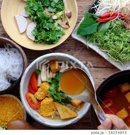 woman hand prepare homemade vegan rieu noodle soup or vegetarian crab paste vermicelli soup 58254953