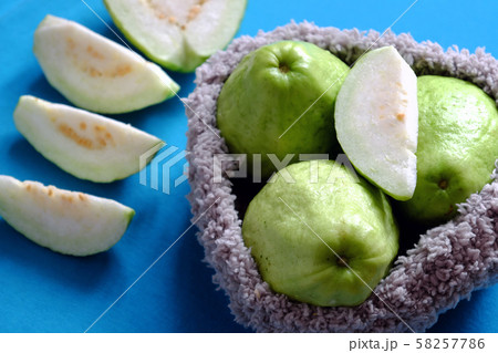 guava fruit with sliced on blue background, rich vitamin c, fiber and cheap 58257786
