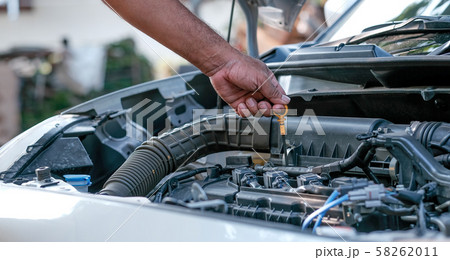 Hands of automotive mechanic check and inspecting 58262011