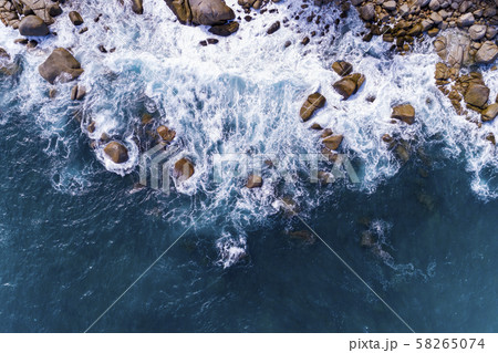 Aerial view of crashing waves on rocks landscape 58265074