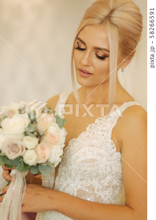 Portrait of gorgeous bride at home. Charming woman with bouquet. Morning of beautiful bride. Wedding Portrait of gorgeous bride at home. Charming woman with bouquet. Morning of beautiful bride. Wedding 58266591