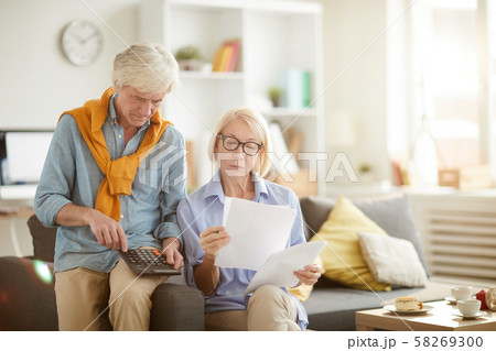 Senior Couple Calculating Taxes Senior Couple Calculating Taxes 58269300