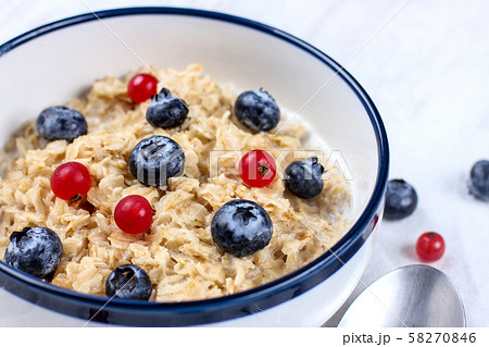 Oatmeal with fresh blueberries and red currant 58270846