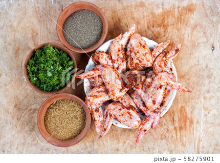 Spices in the bowls with chicken closeup on table Spices in the bowls with chicken closeup on table 58275901