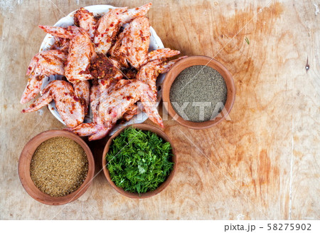 Spices in the bowls with chicken closeup on table Spices in the bowls with chicken closeup on table 58275902