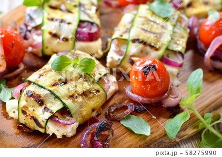 Vegetarian barbecue meal: Grilled Greek feta cheese with red onions wrapped in thin zucchini slices Vegetarian barbecue meal: Grilled Greek feta cheese with red onions wrapped in thin zucchini slices 58275990
