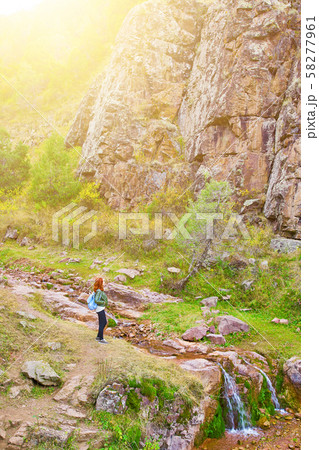 Female hiker walking in mountains forest. Female hiker walking in mountains forest. 58277961