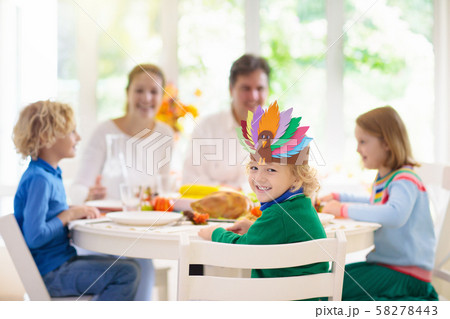 Family with kids at Thanksgiving dinner. Turkey. 58278443