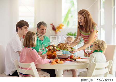 Family with kids at Thanksgiving dinner. Turkey. Family with kids at Thanksgiving dinner. Turkey. 58278444