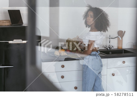 Thoughtful woman going to chop vegetables for dinner 58278511