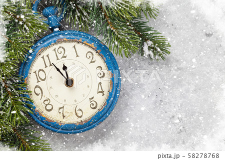 Christmas fir tree and alarm clock over old wood Christmas fir tree and alarm clock over old wood 58278768