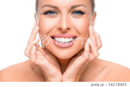 Happy woman enjoying in her healthy skin. Woman touching her face. Anti age concept. Happy woman enjoying in her healthy skin. Woman touching her face. Anti age concept. 58278905