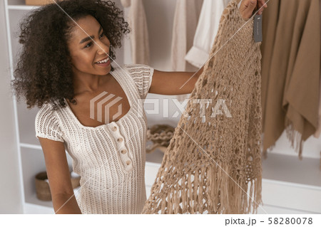 Positive delighted young woman being at home Positive delighted young woman being at home 58280078