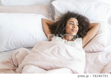 Joyful young brunette girl looking at window 58280791