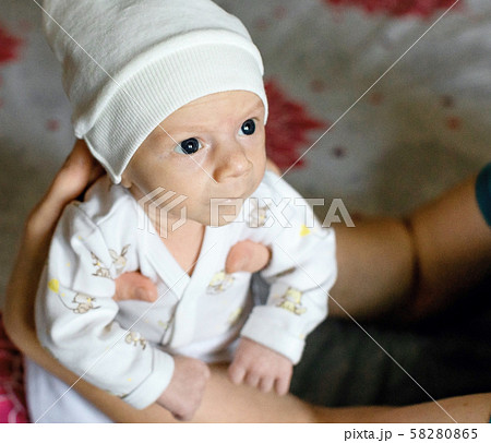 Infant boy in the arms of dad Infant boy in the arms of dad 58280865