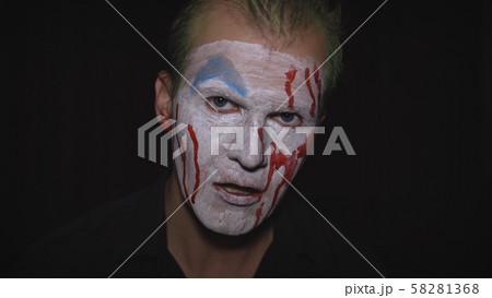 Clown Halloween man portrait. Creepy, evil clowns blood face. White face makeup Clown Halloween man portrait. Creepy, evil clowns blood face. White face makeup 58281368