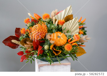 Autumn bouquet of mixed flowers on wooden table. The work of the florist at a flower shop. Fresh cut Autumn bouquet of mixed flowers on wooden table. The work of the florist at a flower shop. Fresh cut 58282572
