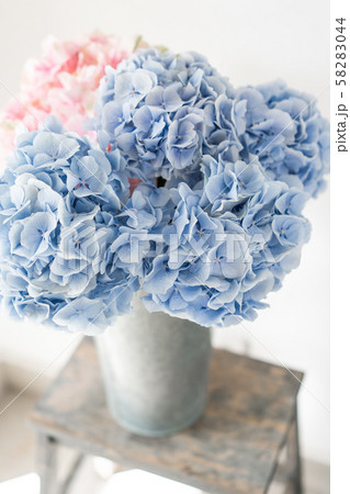 beautiful hydrangea flowers in a vase on a table . Bouquet of light blue. Decoration of home 58283044