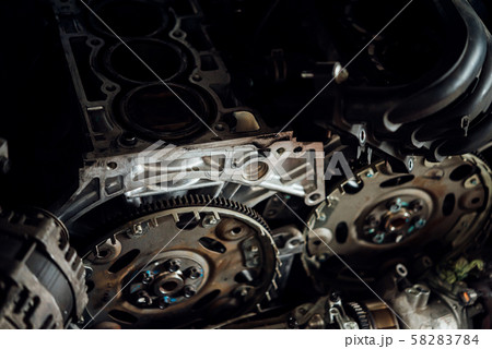 Disassembled car dirty engine and pulley at garage Disassembled car dirty engine and pulley at garage 58283784