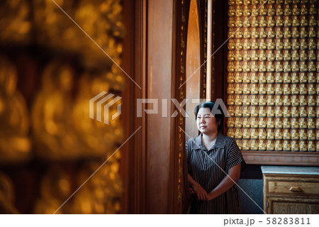 Woman at Wat Boromracha Kanchanapisek Anusorn Woman at Wat Boromracha Kanchanapisek Anusorn 58283811