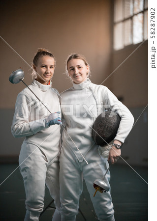 A portrait of two young women fencers 58287902