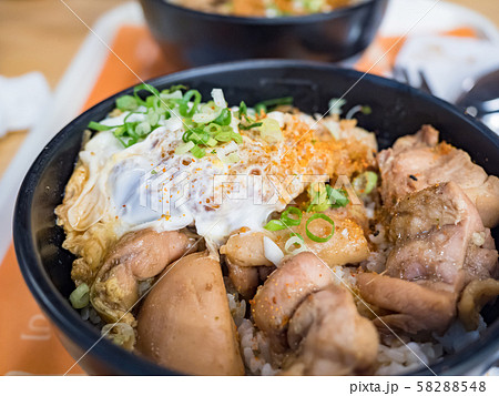 Katsudon is a popular Japanese food, a bowl of rice topped with a deep-fried pork cutlet, egg, vegetables, and condiments. 58288548