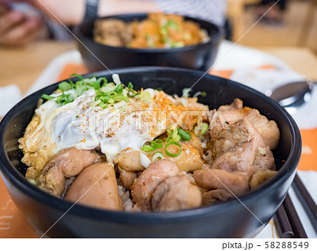 Katsudon is a popular Japanese food, a bowl of rice topped with a deep-fried pork cutlet, egg, vegetables, and condiments. 58288549