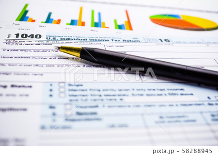Tax Return form 1040 and dollar banknote 58288945