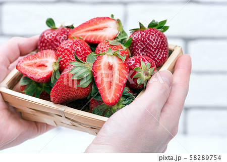 bowl of ripe strawberries in the girl's hands bowl of ripe strawberries in the girl's hands 58289754