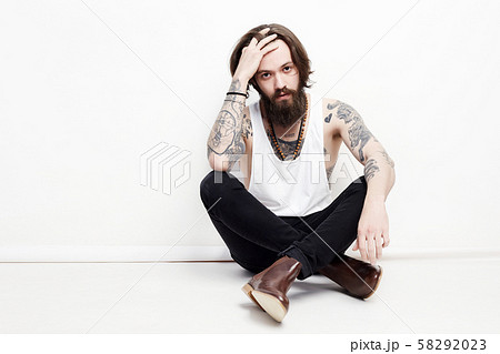 bearded boy with tattoo sitting in studio bearded boy with tattoo sitting in studio 58292023