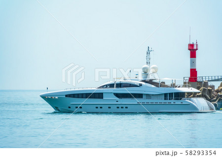 A large white yacht leaves the port. 58293354