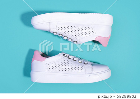 White sneakers on light turquoise background White sneakers on light turquoise background 58299802