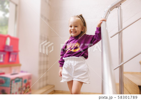 Happy little girl walkning in toy store. Cute girl choose toy. Adorable female in kids mall 58301789