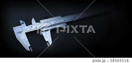Metal Style. Calliper on the Black Metal Background. 58303518