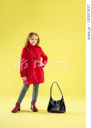 A full length portrait of a bright fashionable girl in a raincoat 58307857