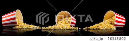 Set of paper striped buckets with scattered popcorn isolated on black background 58313896