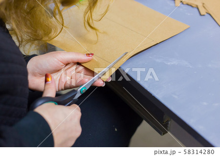 Professional woman decorator, designer working with kraft paper 58314280