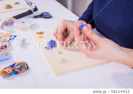 Designer making handmade eardrop 58314422