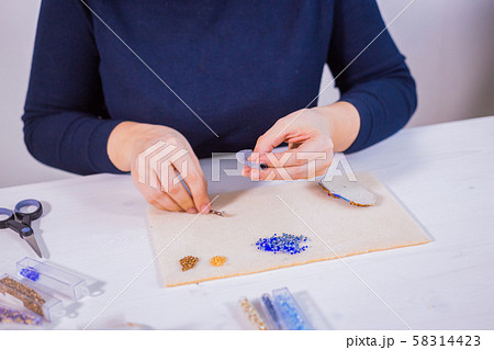 Designer making handmade brooch 58314423