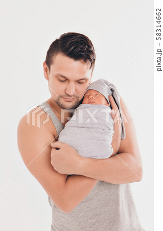Dad holds the baby in his arms. The concept of educating the father of young children, Happy childhood, a friendly family. Dad holds the baby in his arms. The concept of educating the father of young children, Happy childhood, a friendly family. 58314662