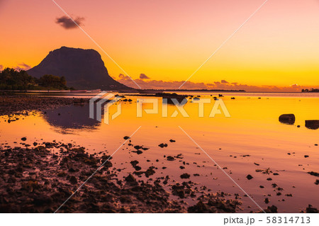 Fishing boats in the sea at sunset time. Le Morn mountain on background in Mauritius. 58314713