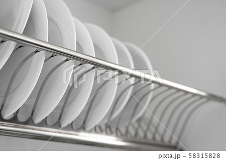 Dish drying metal rack with big nice white clean plates. Traditional comfortable kitchen. Open white 58315828