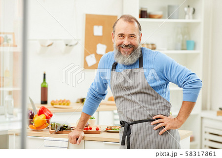 Smiling Senior Man Cooking in Kitchen 58317861