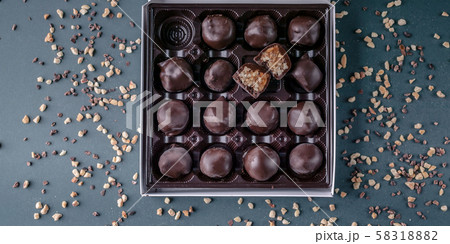 Food banner: Handmade chocolates with honey and nuts. Gourmet Chocolate in a Gift Box. Top view 58318882