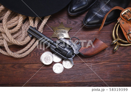 Old western gun with marshal badge and silver Old western gun with marshal badge and silver 58319399