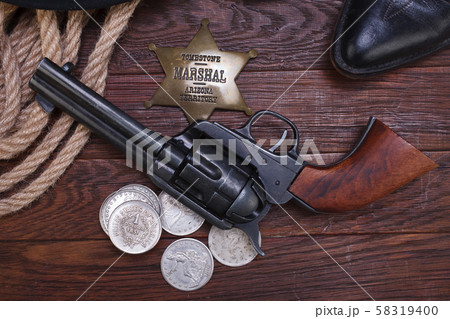 Old western gun with marshal badge and silver 58319400