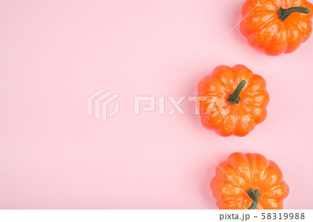 Pink background with three pumpkins. 58319988